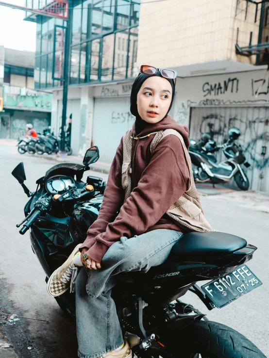 a woman sitting on the seat of a motorcycle