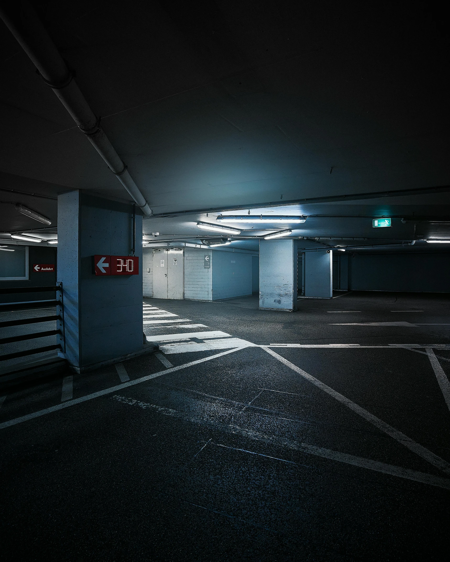 a dark parking garage with the door open