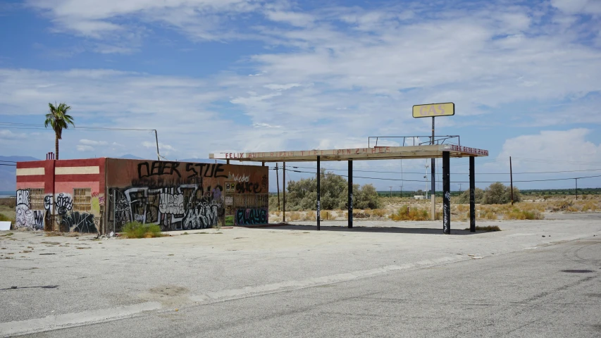 an empty parking lot next to some graffiti