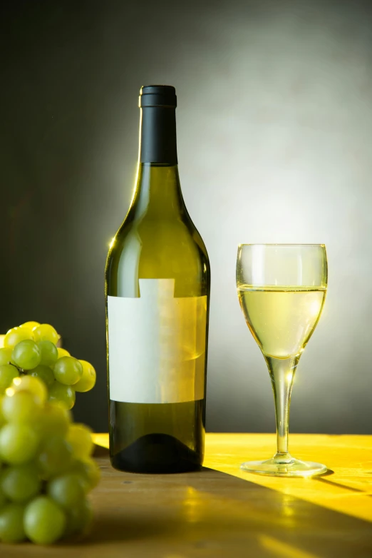 a bottle and glass on a table with a bunch of gs