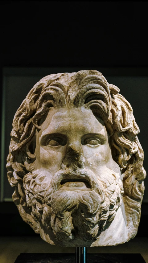 an old statue is of a bearded man