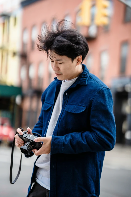 a man standing in the street and taking a picture