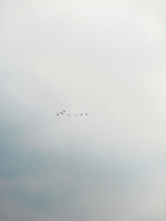 several planes flying overhead in the sky on a sunny day