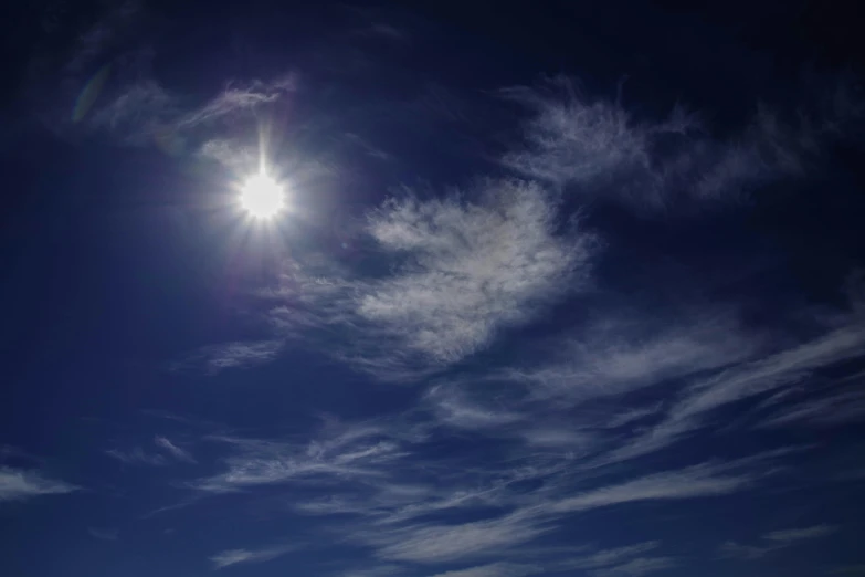 the sun shining above some white clouds in the sky