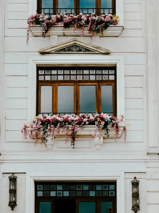 a building is displaying flowers and lampposts