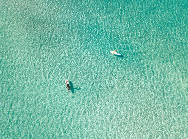 the two small boats are in the water