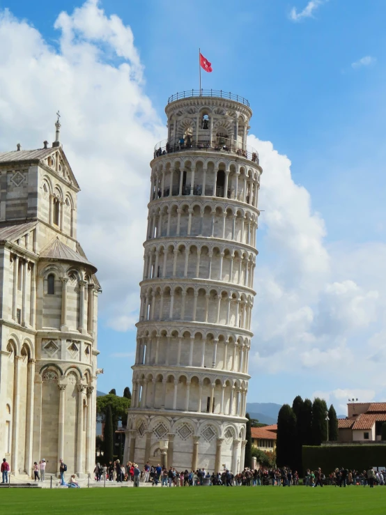 the leaning tower of pisa is tall and full of people