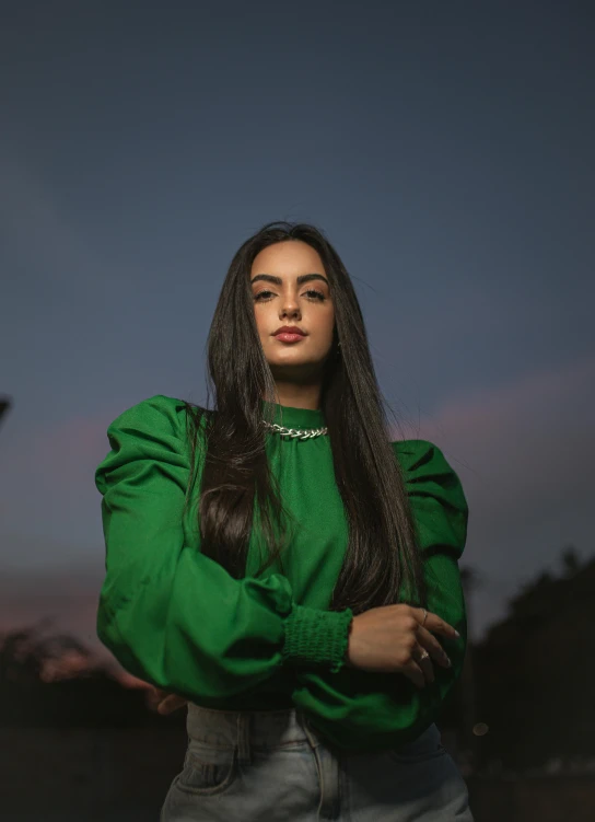 a close up of a woman wearing a green top