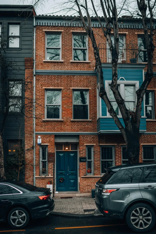 a very big cute brick building near a few cars