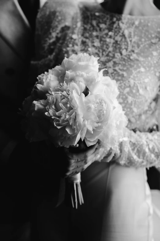 a close up of a person holding a bouquet