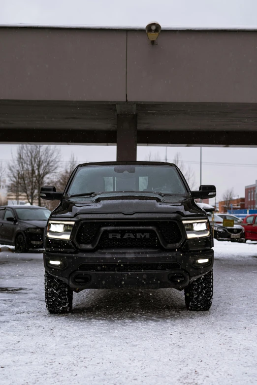 a truck with headlights is parked in the snow