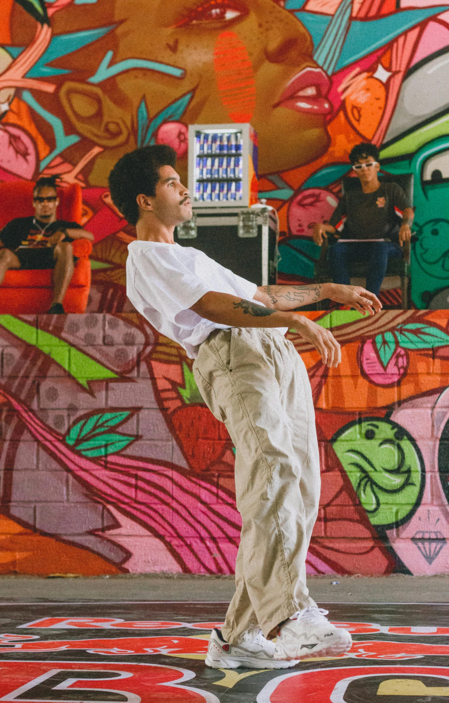 a man practicing yoga in front of a mural