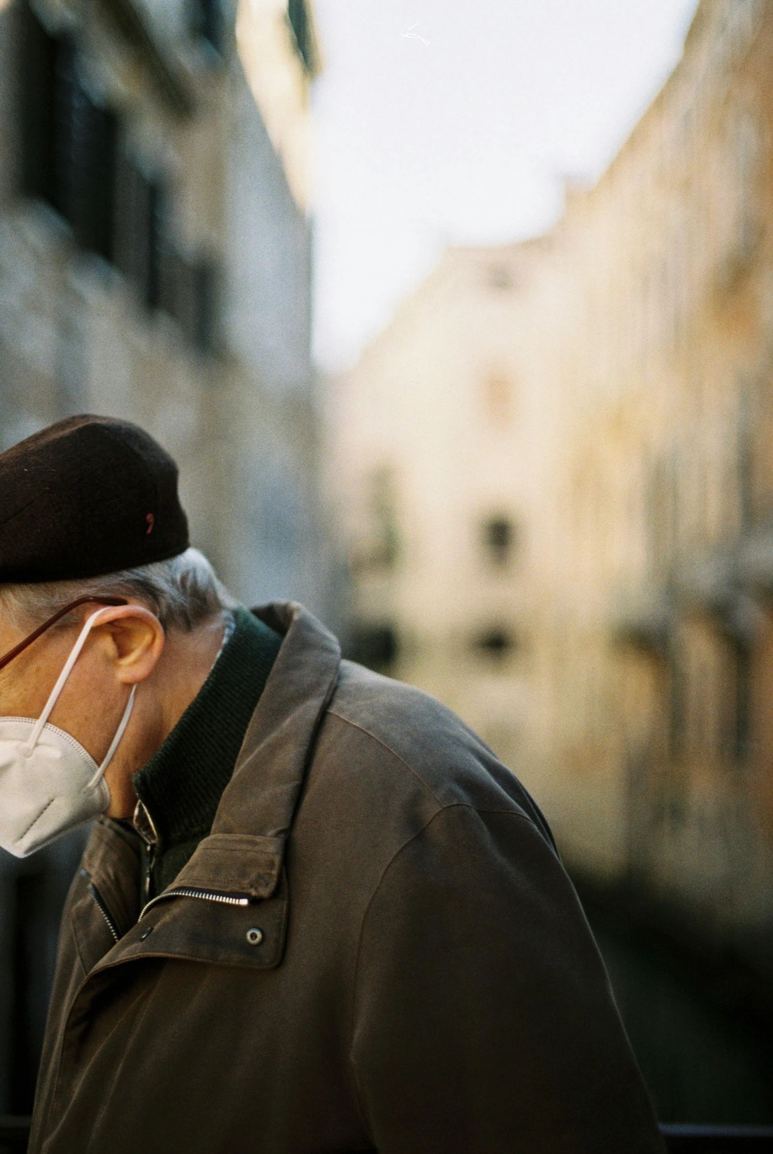 a man wearing a surgical mask with earbuds on