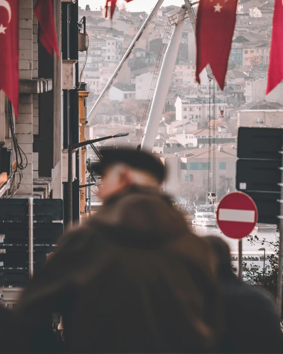 a man looks out over the city from above