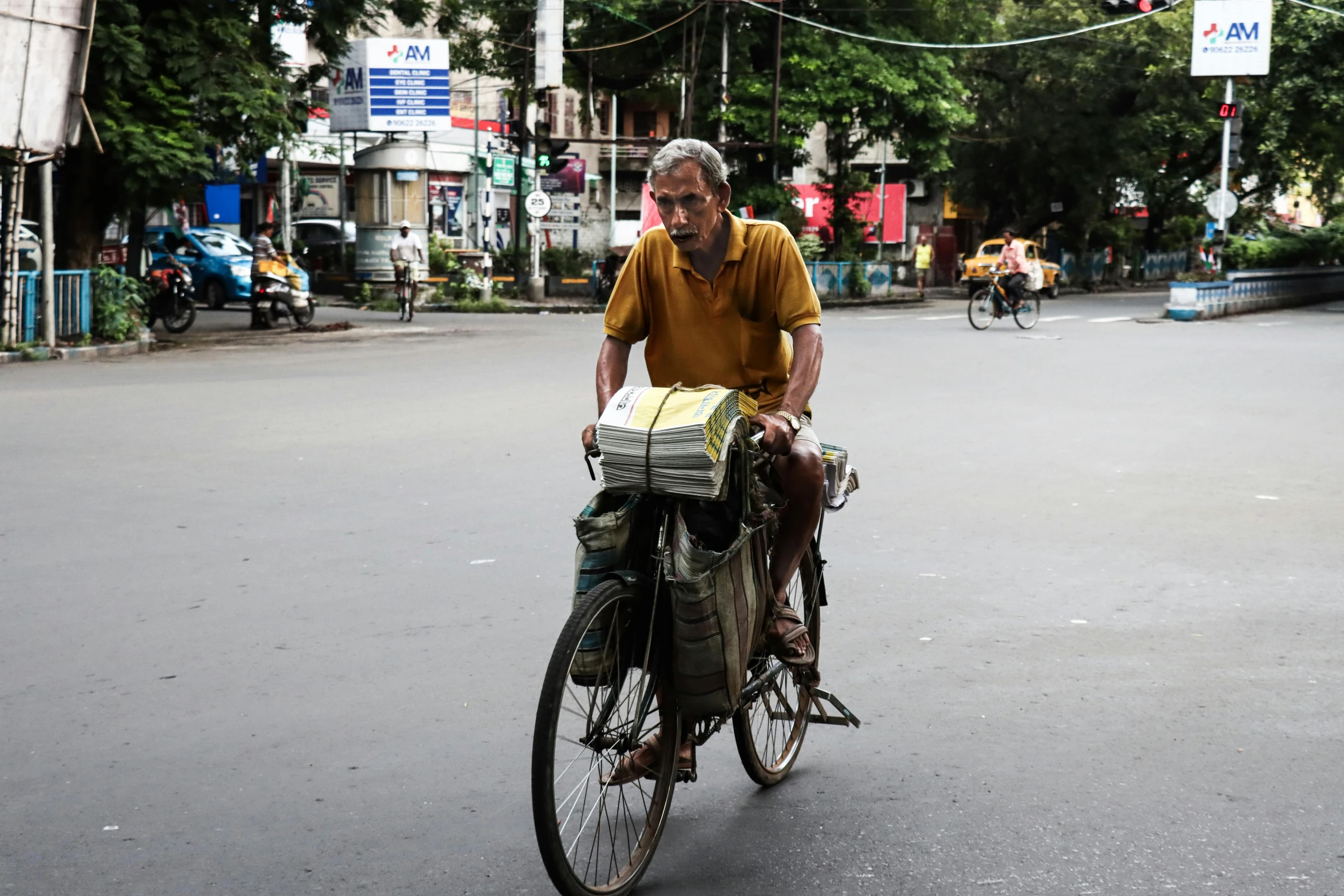 the older man rides his bike down the street