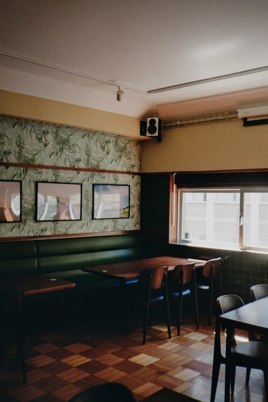 an empty restaurant area with multiple seats and long tables