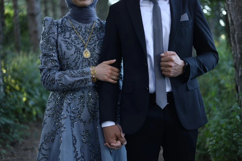 the young couple is posing for a po in their formal wear