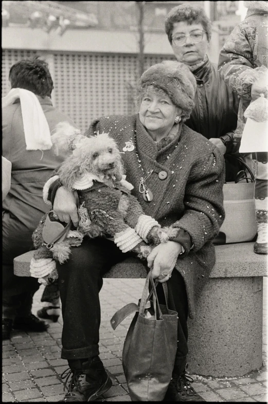 the old woman is sitting next to the man holding a teddy bear