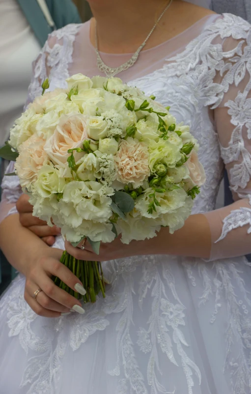 a beautiful bride holding her bridal bouquet