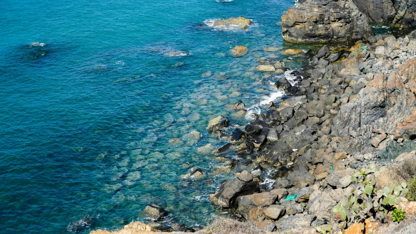 a bird's eye view of the water and cliffs near the beach