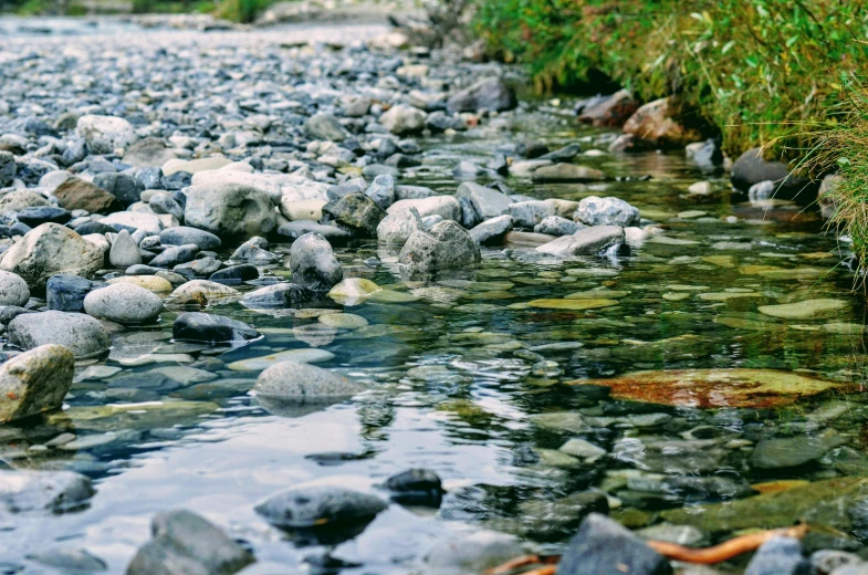 a stream running by some rocks in the water