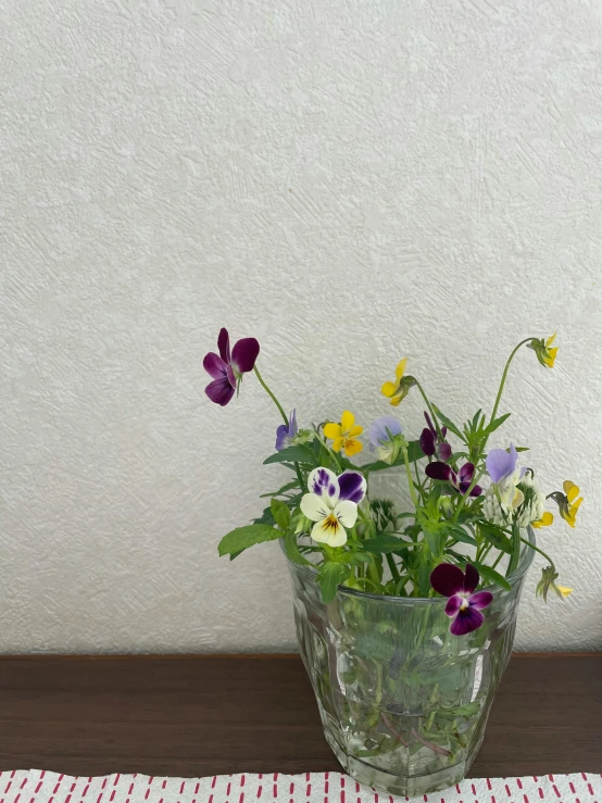 a vase filled with a bunch of flowers on top of a table