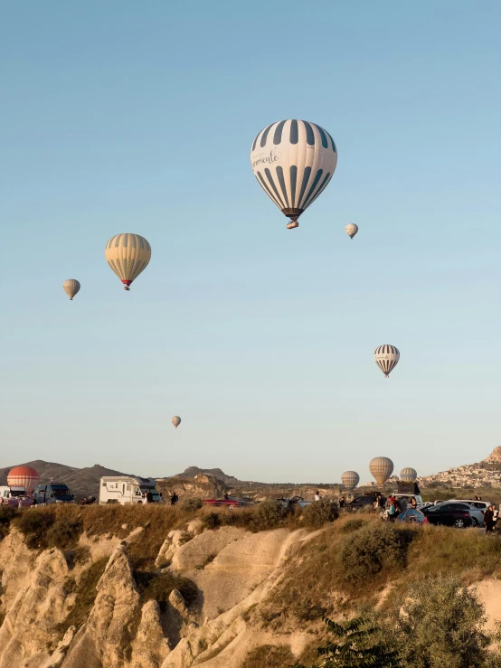 a field filled with lots of  air balloons