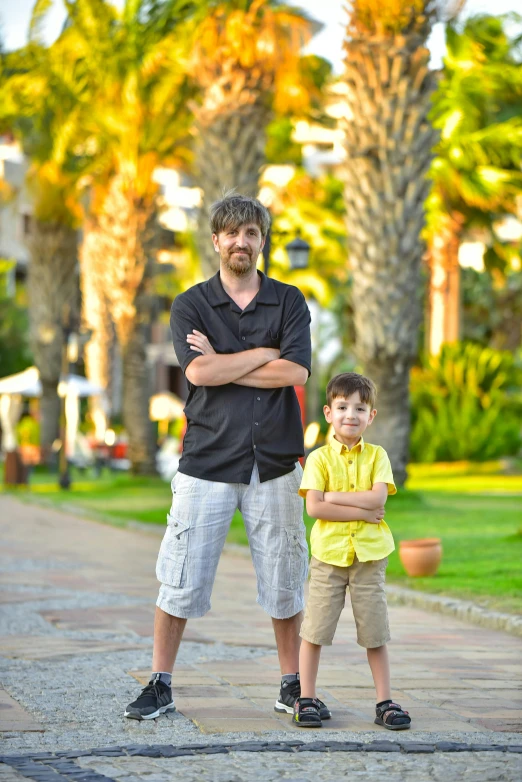 a father and son posing for a pograph together