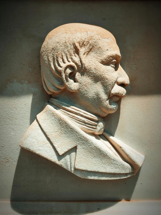 a statue of a man is shown next to a wall