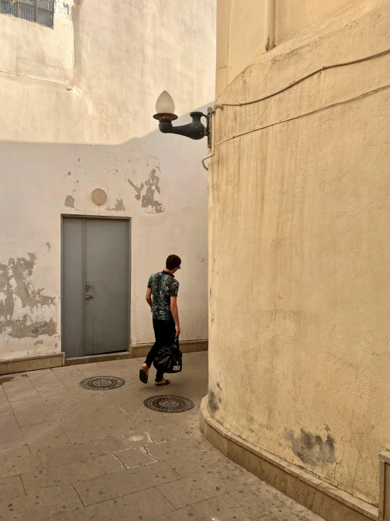 a man walking past a closed door on the street