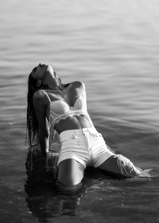 a young woman is posing for a po in the water