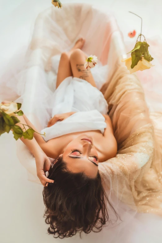 a girl wearing white laying on her stomach