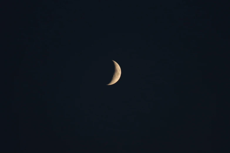 the half moon in a dark sky at night