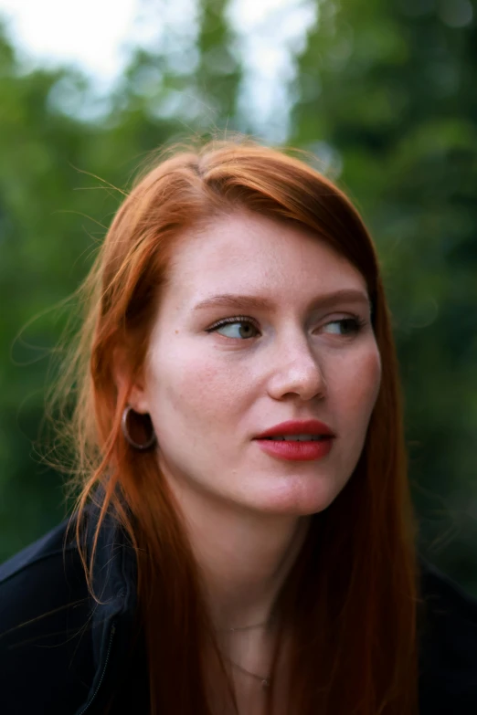 a woman with frecky hair looking back