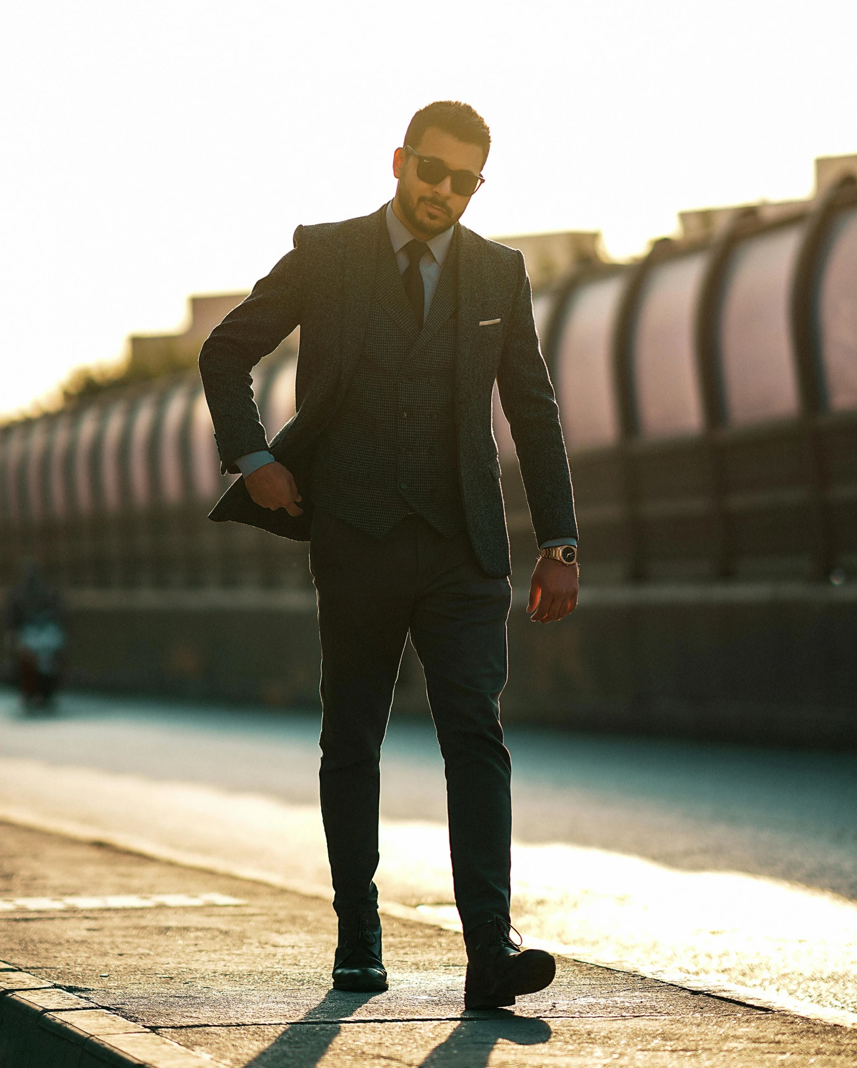 man in suit and tie looking to his left at the camera