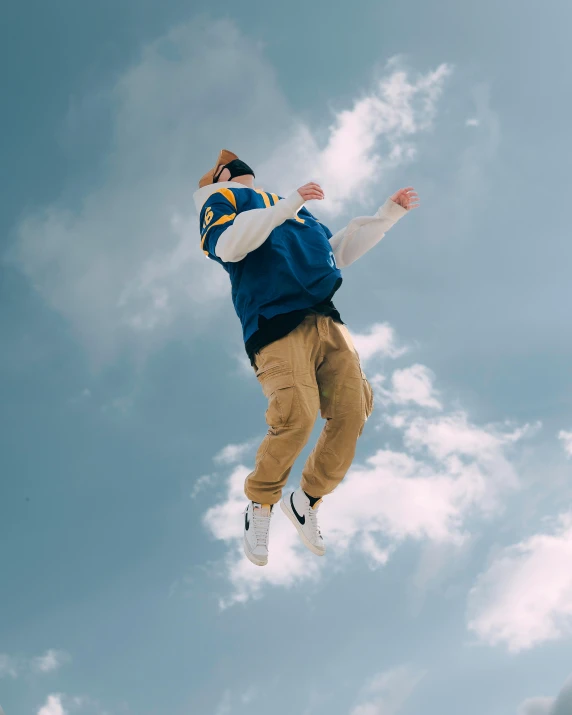 the man is flying through the air while on his skateboard