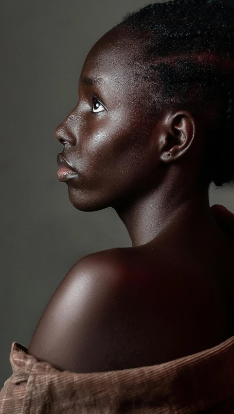 a woman with dark makeup and freckles on her face