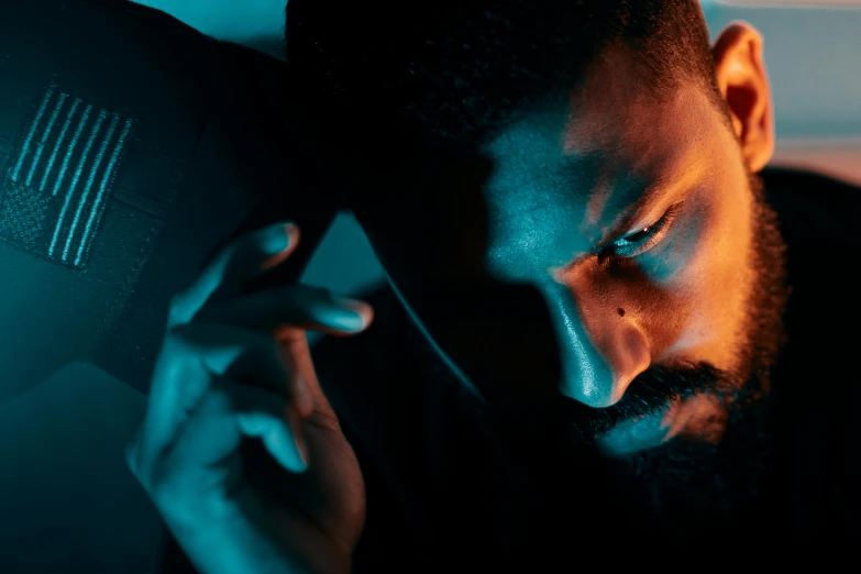 a man sitting down while looking at his phone