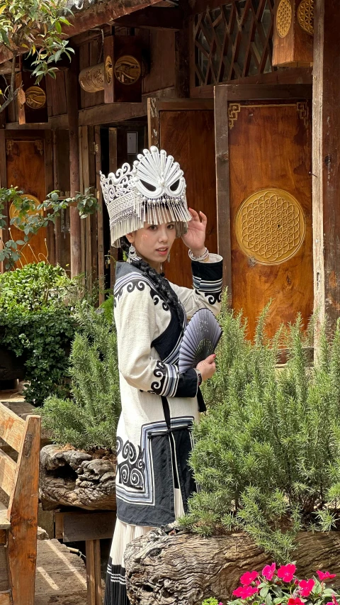 a young woman dressed in a native costume and holding a basket