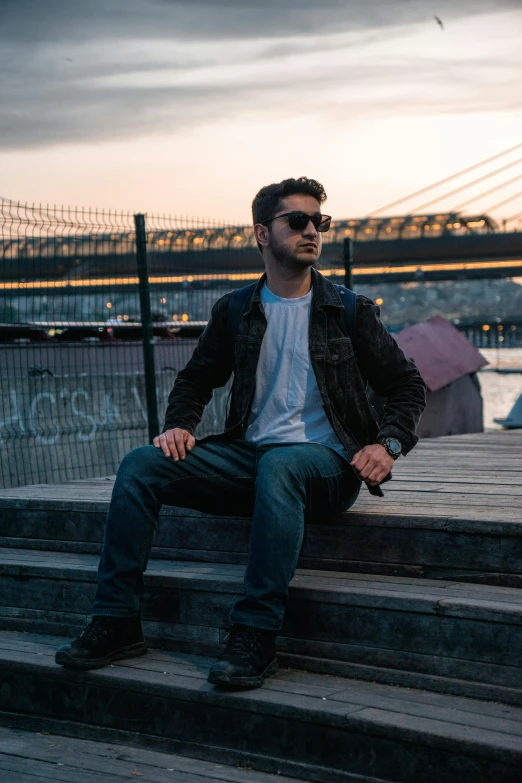 a man sitting on top of a concrete stair case