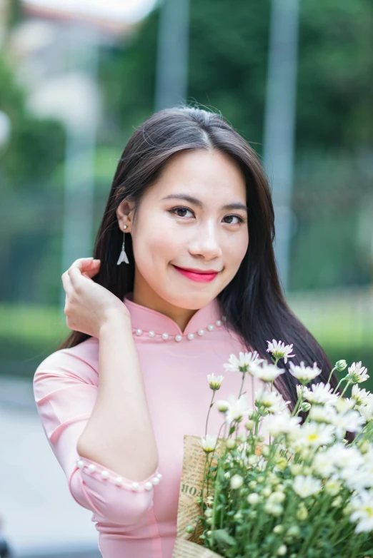 a pretty young lady holding a vase of flowers