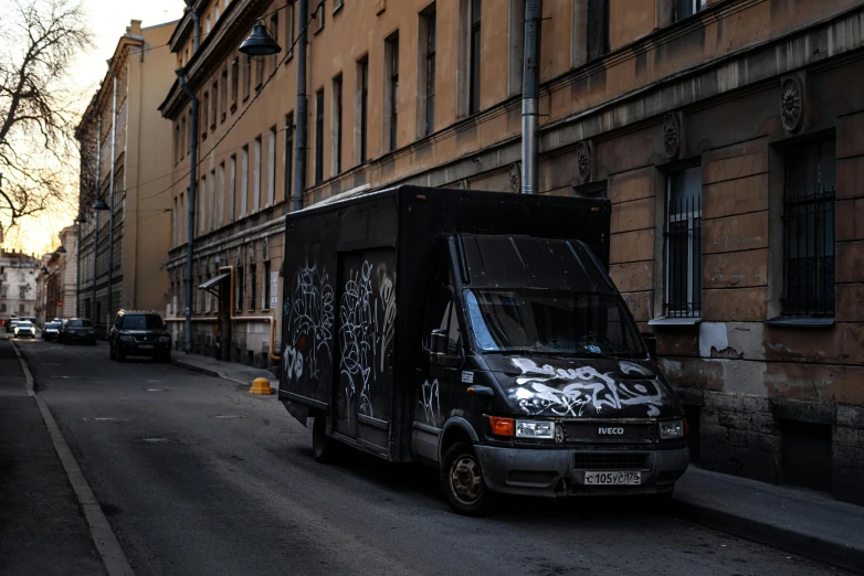 a van parked on a city street near a building