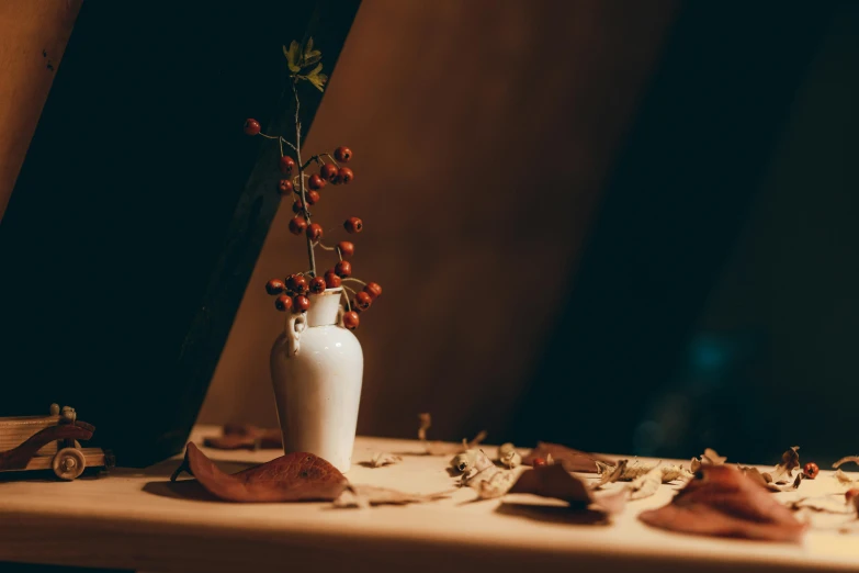 a vase and flower sit on the edge of a counter