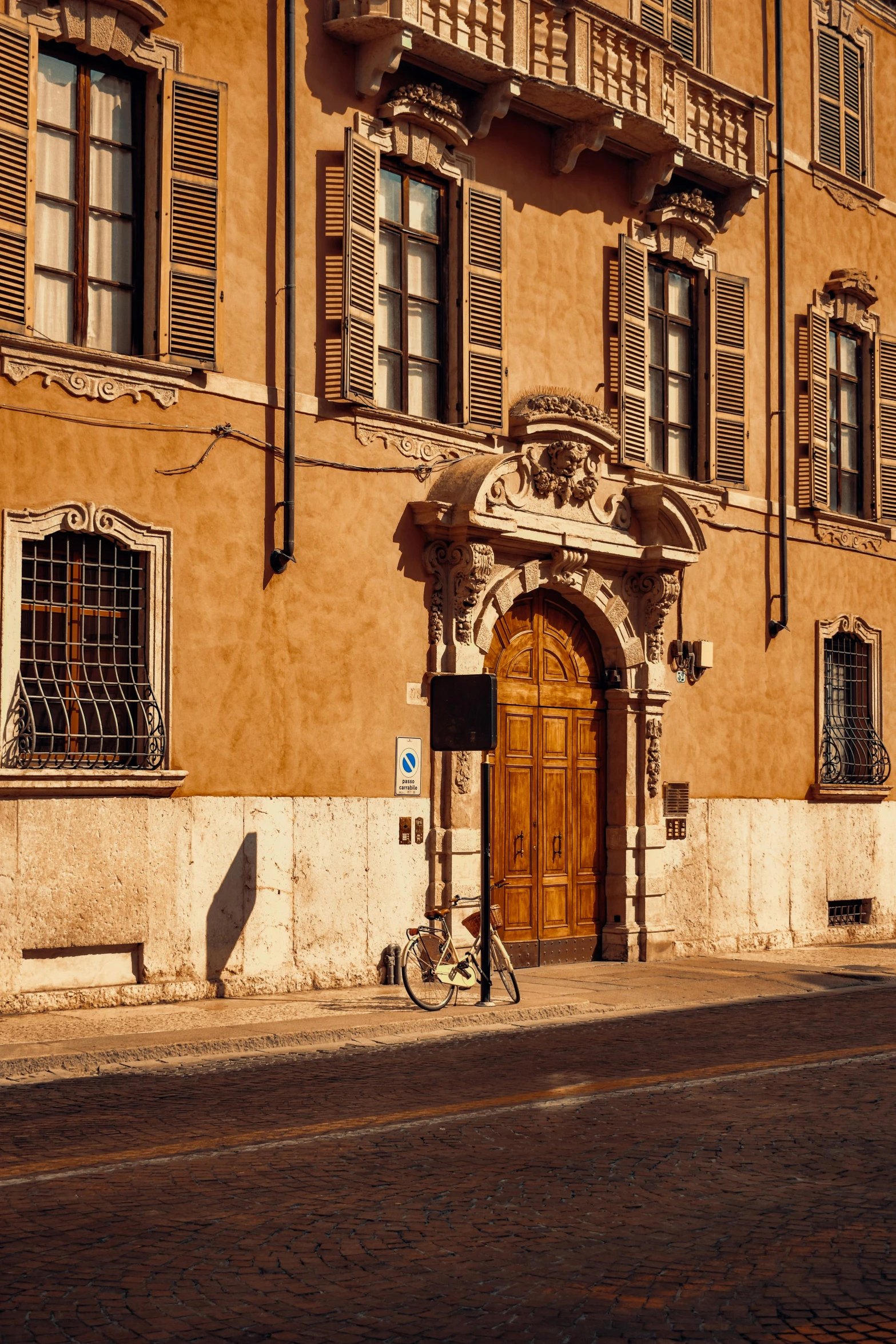 a large brown building with shuttered window shutters