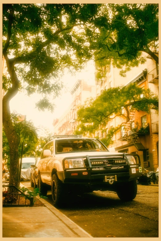 an suv is parked on the curb outside a residential building