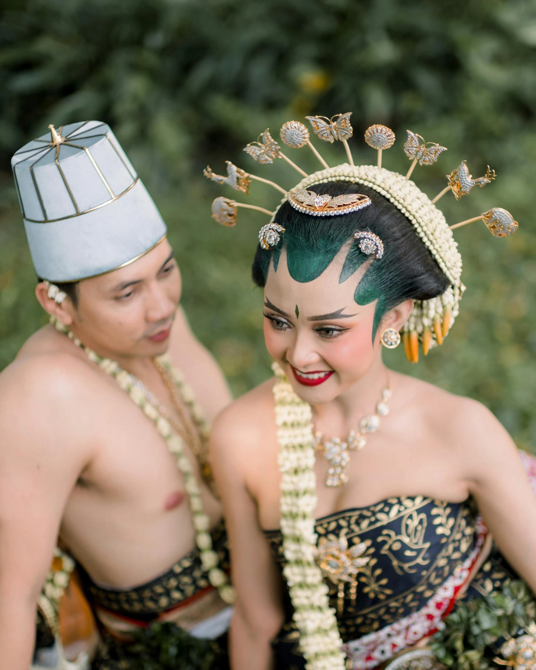 a man and woman wearing thai costume and makeup