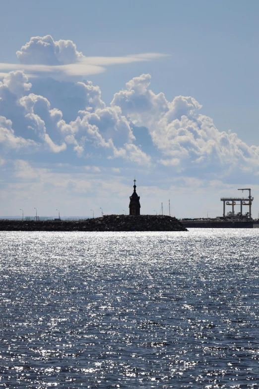 a light house is on an island by the water