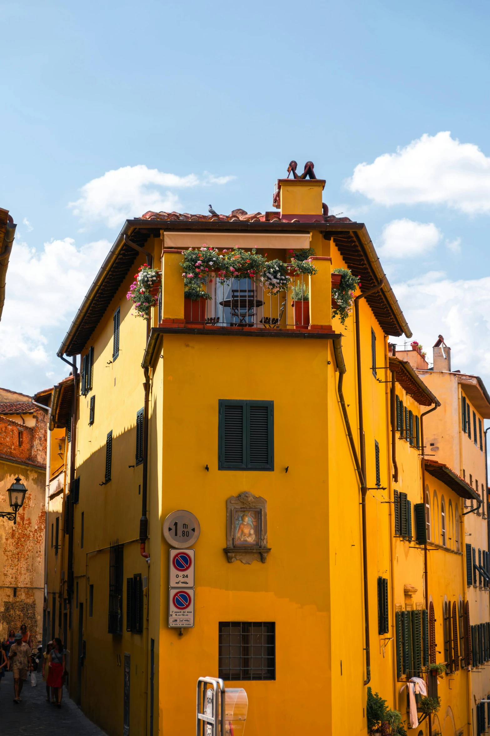 a tall yellow building sitting on the side of a road