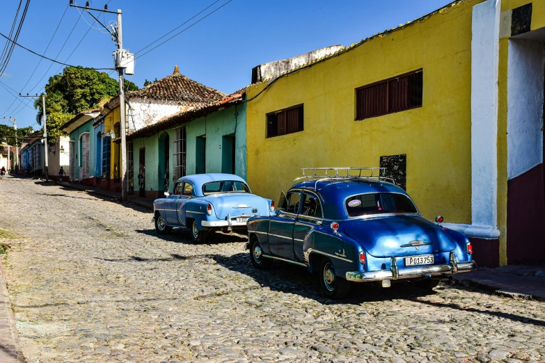 old cars parked on the side of the road