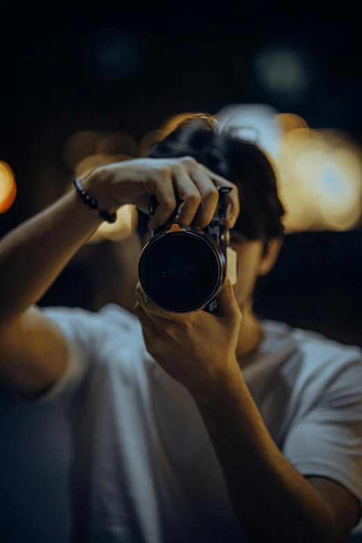 a man holding his camera with his right hand